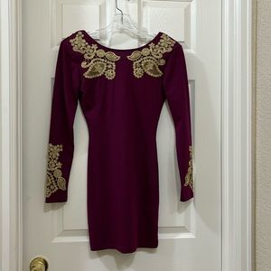 Young woman’s dress with gold detailing, stretchy knit fabric with long sleeves